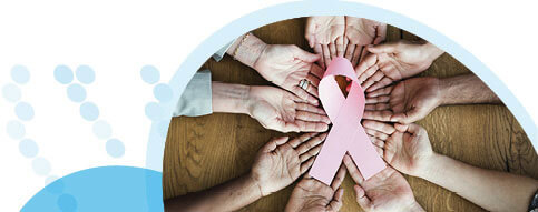 כפות ידיים פרושות במעגל ועליהן סרט ורוד המסמל את חודש המודעות לסרטן השד